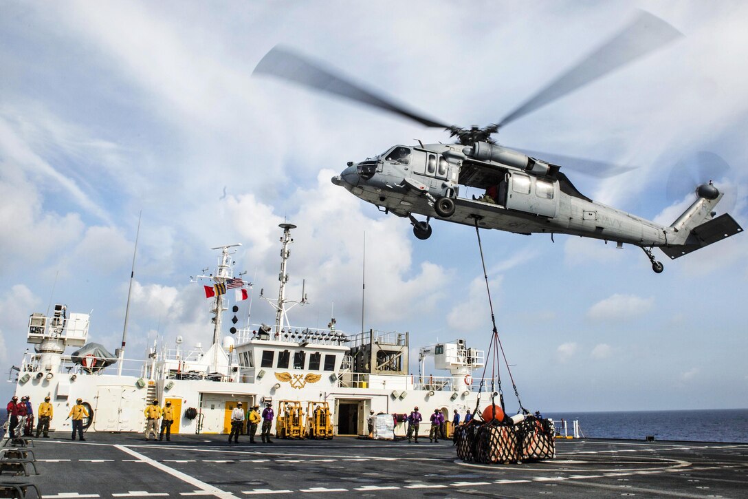 An MH-60S Sea Hawk helicopter assigned to Helicopter Sea Combat Squadron 25 approaches the flight deck of hospital ship USNS Mercy during a vertical replenishment in the South China Sea, July 13, 2016. The Mercy, which is deployed in support of Pacific Partnership 2016, is en route to its third mission stop in Da Nang, Vietnam. Upon arrival, partner nations will work side by side with local military and non-government organizations to better prepare for a natural disaster or crisis. Marine Corps photo by Sgt. Brittney Vella