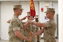 NAVAL SUPPORT FACILITY INDIAN HEAD, MD -- Capt. Lucas H. Forcella (right) passes the Headquarters and Service Company guidon to Capt. Robert G. Ukrainec during a change of command ceremony at Naval Support Facility Indian Head, Md., July 13, 2016. This Marine Corps drill movement symbolizes the passing of authority from outgoing to incoming company commander. (Official USMC Photo by Sgt. Jonathan S. Herrera/Released)
