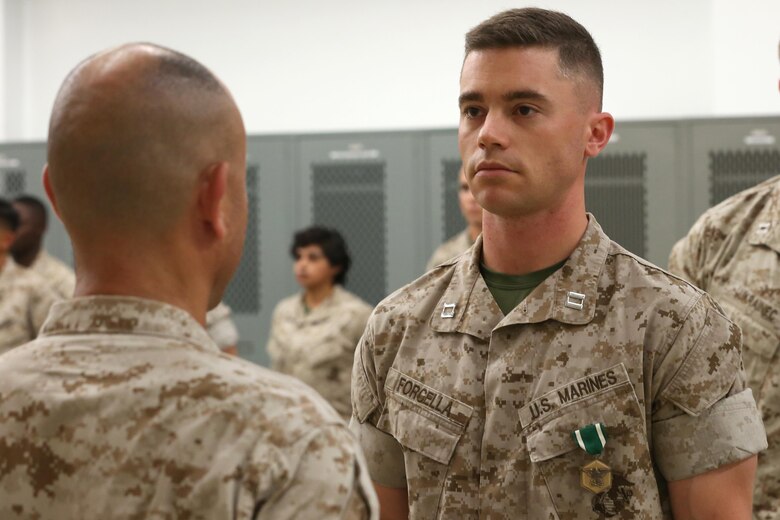 NAVAL SUPPORT FACILITY INDIAN HEAD, MD -- Col. Michael L. Carter, commanding officer of Chemical Biological Incident Response Force, presents Capt. Lucas H. Forcella with a Navy and Marine Corps Commendation Medal following a change of command ceremony at Naval Support Facility Indian Head, Md., July 13, 2016. Forcella served as the company commander for Headquarters and Service Company and relinquished command to Capt. Robert G. Ukrainec. (Official USMC Photo by Sgt. Jonathan S. Herrera/Released)
