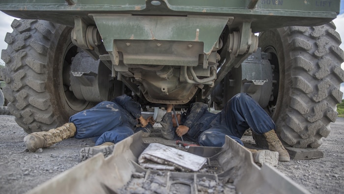 Cpl. Phim P. Yang (left), an automotive maintenance technician with Engineer Support Company, 6th Engineer Support Battalion, 4th Marine Logistics Group, Marine Forces Reserve, and Pfc. Rafael Becerra, an engineer equipment mechanic with Detachment (-), Marine Wing Support Squadron-473, Marine Aircraft Group 41, 4th Marine Aircraft Wing, perform maintenance on a 120M motor grader during Innovative Readiness Training Old Harbor, Alaska, July 10, 2016. IRT Old Harbor is part of a civil and joint military program to improve military readiness while simultaneously providing quality services to underserved communities throughout the United States.