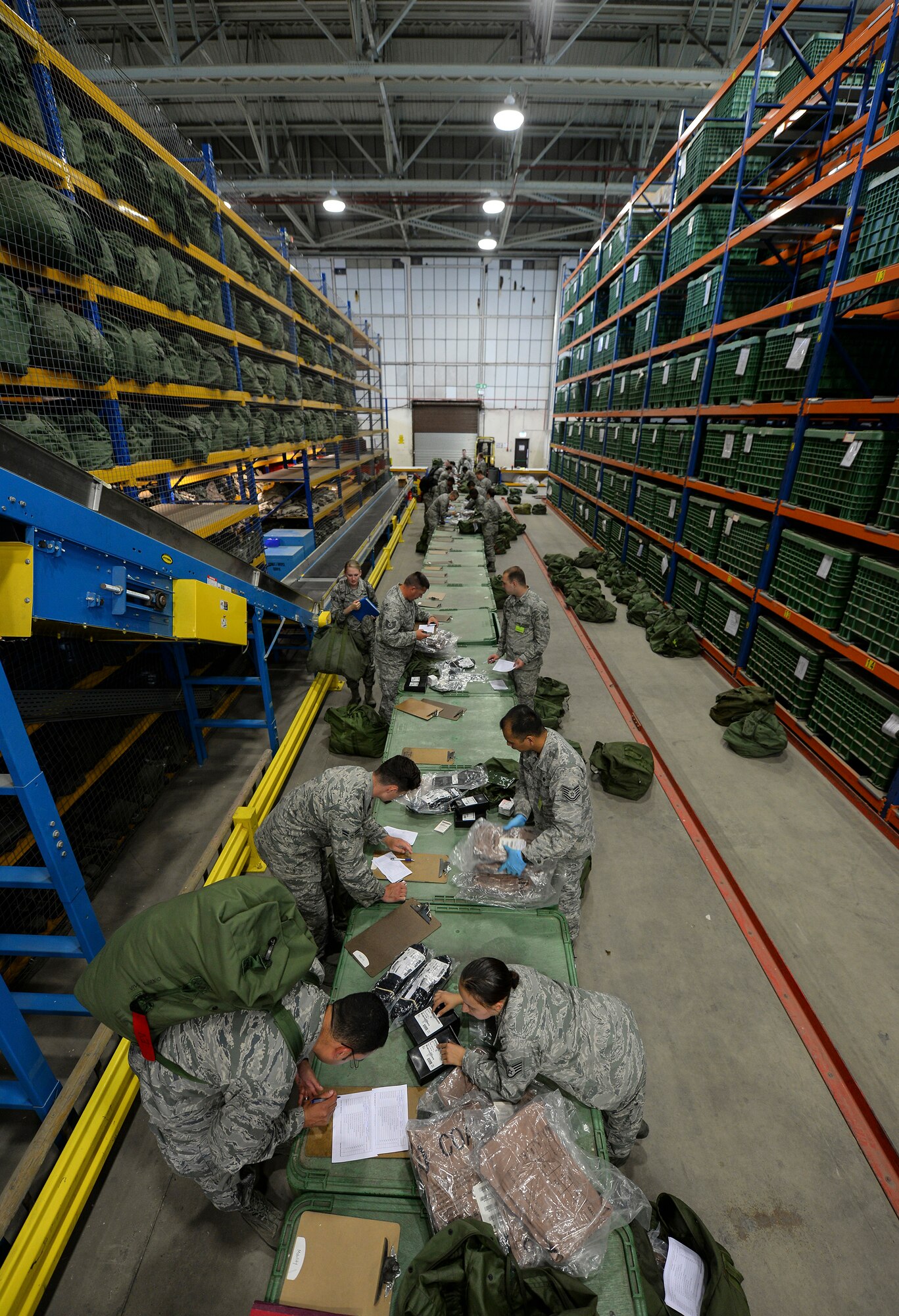 U.S. Air Force Airmen process through the 100th Logistics Readiness Squadron mobility section during an exercise July 14, 2016, on RAF Mildenhall, England. Airmen from various units were selected for the exercise and divided into chalks to streamline out-processing. (U.S. Air Force photo by Staff Sgt. Micaiah Anthony)