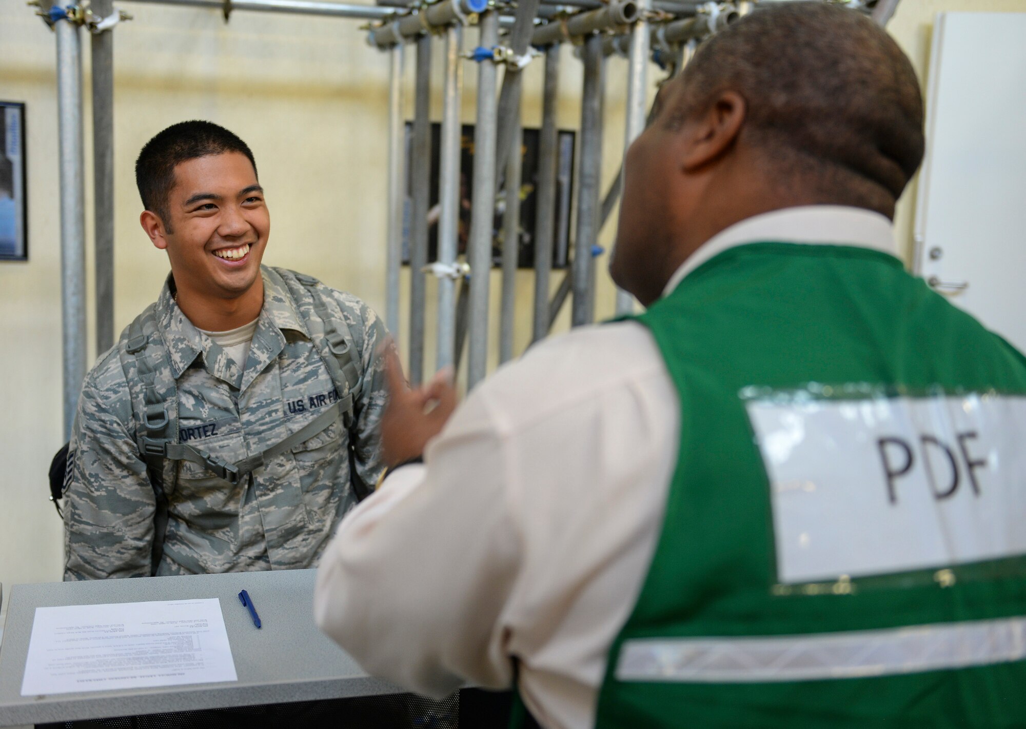 U.S. Air Force Staff Sgt. Michael Cortez, left, 100th Aircraft Maintenance Squadron KC-135 Stratotanker communication navigation craftsman, listens to a briefing from Christopher Rhett, 100th Force Support Squadron Airmen and Family Readiness Center community readiness specialist, in the personnel deployment function line during an exercise July 14, 2016, on RAF Mildenhall, England. The exercise was conducted to test the base’s ability to quickly respond to threats and assist NATO allies. (U.S. Air Force photo by Staff Sgt. Micaiah Anthony)