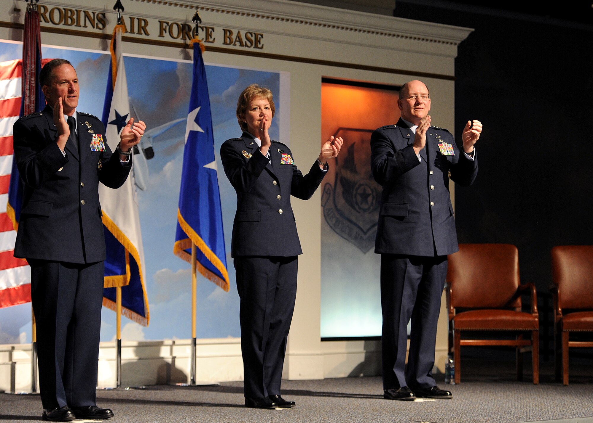 Chief of Staff of the Air Force, Gen. David L. Goldfein, and newly appointed commander of Air Force Reserve Command, Lt. Gen. Maryanne Miller and former commander of AFRC, Lt. Gen. James F. Jackson, sing the Air Force song at the conclusion of Miller's change of command ceremony at the Museum of Aviation in Warner Robins, Ga., July 15, 2016. Miller became the first female to assume command of AFRC. (U.S. Air Force photo by Tech. Sgt. Stephen D. Schester)