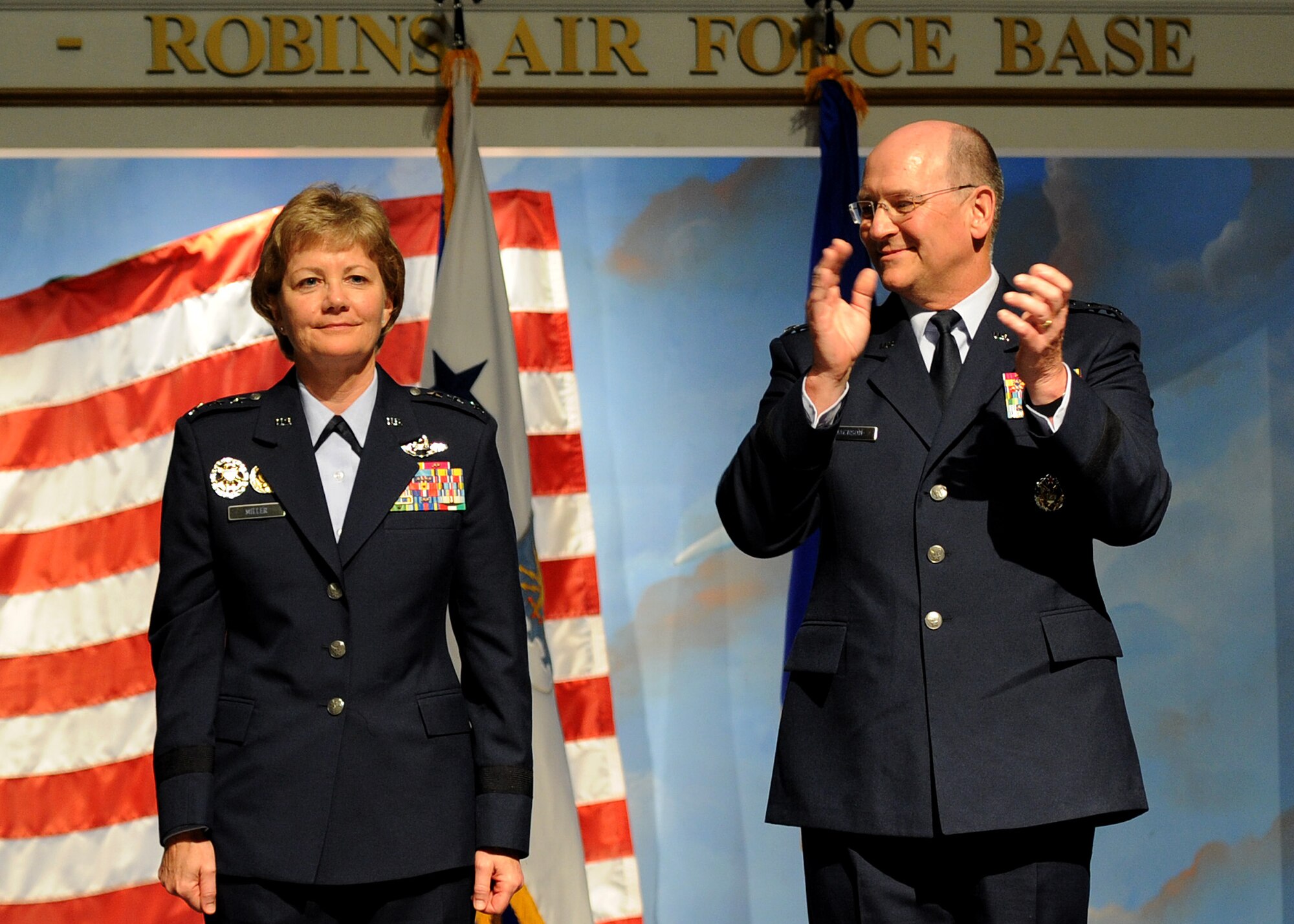 Newly appointed commander of Air Force Reserve Command, Lt. Gen. Maryanne Miller, stands next to the former commander of AFRC, Lt. Gen. James F. Jackson, as he congratulates her on the new position during the change of command ceremony at the Museum of Aviation in Warner Robins, Ga., July 15, 2016. Miller became the first female to assume command of AFRC. (U.S. Air Force photo by Tech. Sgt. Stephen D. Schester)