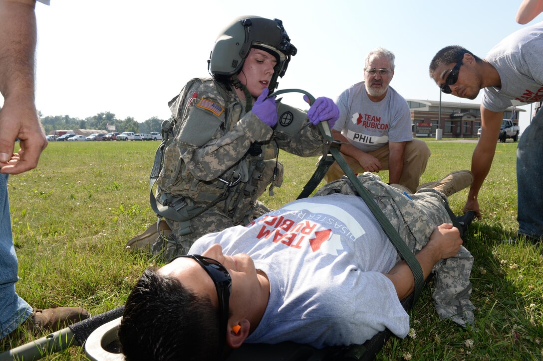 Nebraska Army National Guard Sgt. Samantha Herschenbach, left, and Team Rubicon safety officer Timothy “Guns” Waynick, right, treat simulated patients during medical evacuation training with a UH-72 Lakota Helicopter, part of the National Guard exercise Patriot North 2016 at Volk Field Air National Guard Base, Wis. July 18, 2016. Team Rubicon is a civilian volunteer organization of military veterans and first responders that rapidly deploys emergency response teams at the request of federal, state and county agencies. PATRIOT is an annual exercise to test capabilities and develop relationships with first responders and agencies. Herschenbach is an Army flight medic assigned to the D Company 1-376th Aviation Battalion, Nebraska Army National Guard. Air National Guard photo by Senior Master Sgt. David H. Lipp