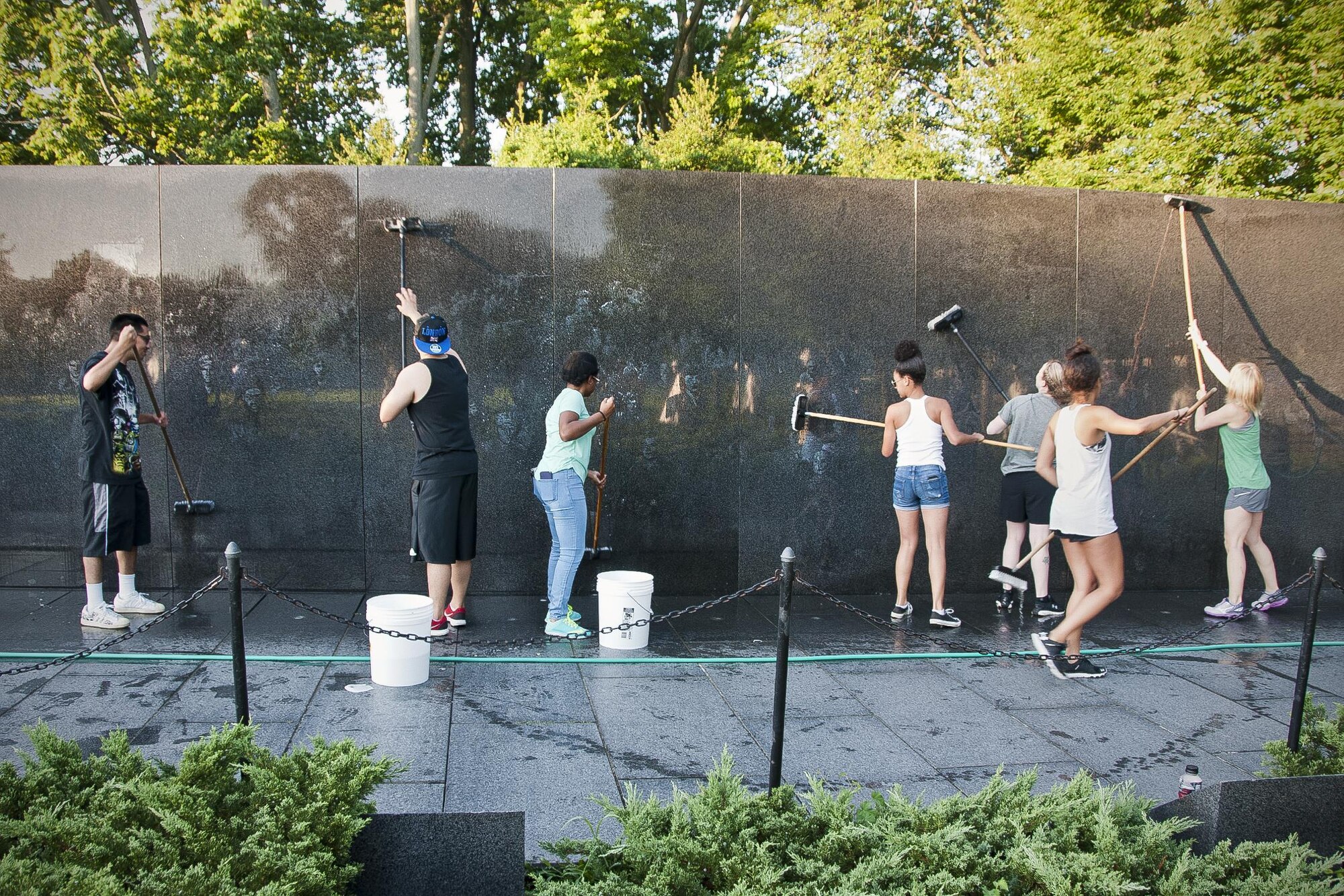 Members of the 459th Air Refueling Wing wash the Korean War Veterans Memorial wall in Washington D.C., July 17, 2016. Volunteers from the 459th ARW came out in the early morning hours to clean the memorial prior to the arrival of daily visitors. (U.S. Air Force photo/Staff Sgt. Kat Justen)
