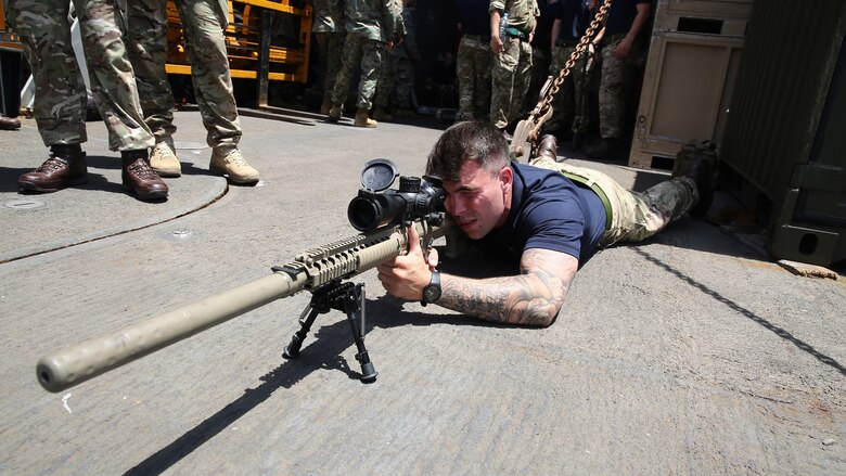 A United Kingdom Royal Marine sights in on a semi-automatic sniper system during an explosive ordnance disposal demonstration aboard the amphibious dock landing ship USS Whidbey Island, July 8, 2016. 22nd MEU, deployed with the Wasp Amphibious Ready Group, is conducting naval operations in the U.S. 6th Fleet area of operations in support of U.S. national security interests in Europe. 