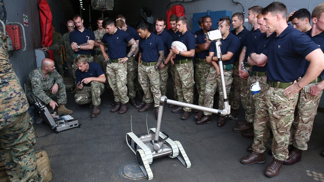 Marine Staff Sgt. Robert Schmitt, left, an explosive ordnance disposal technician with 22nd Marine Expeditionary Unit, demonstrates EOD capabilities for the United Kingdom Royal Marines in order to promote interoperability aboard the amphibious dock landing ship USS Whidbey Island, July 8, 2016. 22nd MEU, deployed with the Wasp Amphibious Ready Group, is conducting naval operations in the U.S. 6th Fleet area of operations in support of U.S. national security interests in Europe. 