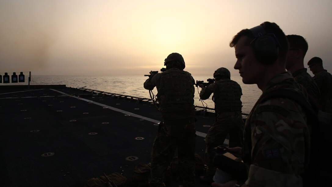 United Kingdom British Royal Marines fire M4 carbines during a demonstration with 22nd Marine Expeditionary Unit aboard the amphibious dock landing ship USS Whidbey Island, July 8, 2016. 22nd MEU, deployed with the Wasp Amphibious Ready Group, is conducting naval operations in the U.S. 6th Fleet area of operations in support of U.S. national security interests in Europe. 