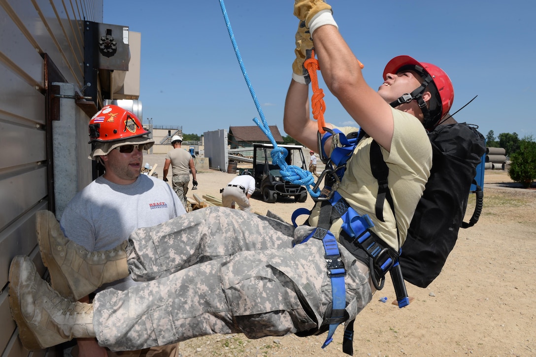 Wisconsin Army National Guard Spc. Christopher Howell climbs a wall while Matt Trepczyk, a senior instructor for the Regional Emergency All-Climate Training Center, provides rope rescue instruction during Exercise Patriot North 2016 at Volk Field Air National Guard Base, Wis., July 18, 2016. Air National Guard photo by Senior Master Sgt. David H. Lipp