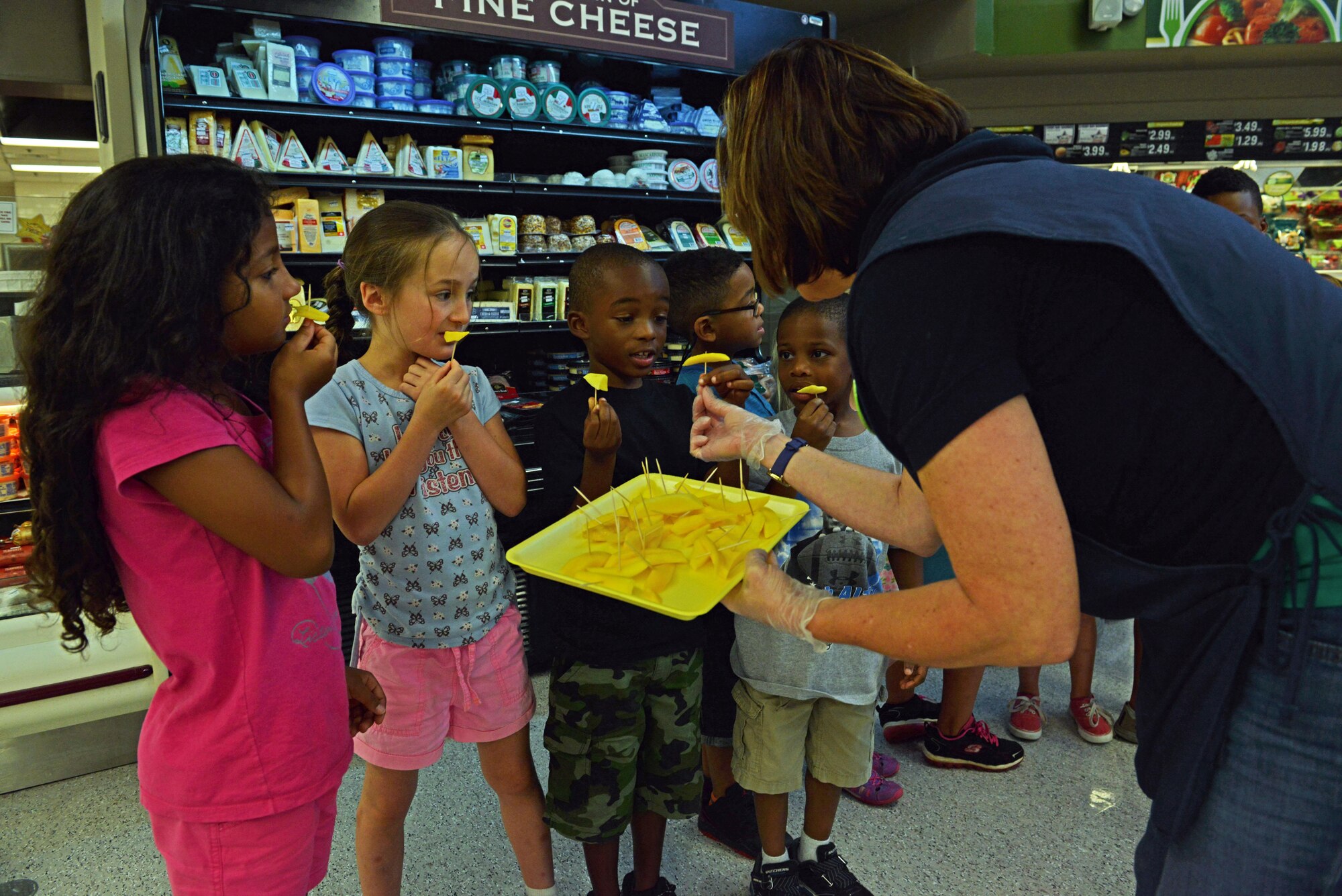 Team Shaw children try mango slices during a Healthy Lifestyle Festival at the Shaw Commissary at Shaw Air Force Base, S.C., July 15, 2016. During the festival, children from the Shaw Child Development Center tried various healthy snacks from the commissary such as bell peppers, veggie burgers, and mangoes. (U.S. Air Force photo by Airman 1st Class Destinee Dougherty)