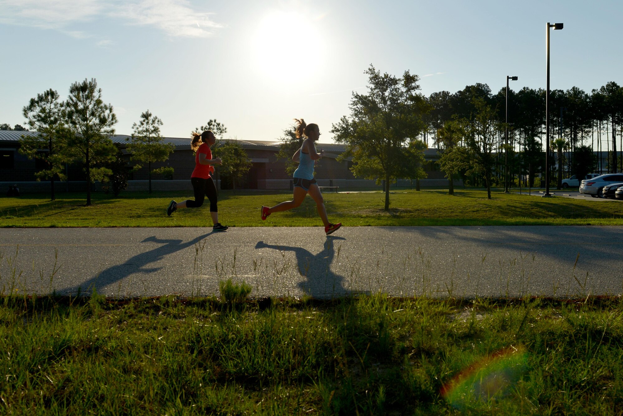 Two runners race toward the finish line during a 5K run during a Healthy Lifestyle Festival at Shaw Air Force Base, July 15, 2016. The Healthy Lifestyle Festival promoted physical fitness with the run as well as an aerobathon, featuring Zumba, kickboxing and yoga taught by volunteer instructors from the Shaw Fitness and Health Center. (U.S. Air Force photos by Airman 1st Class Destinee Dougherty)