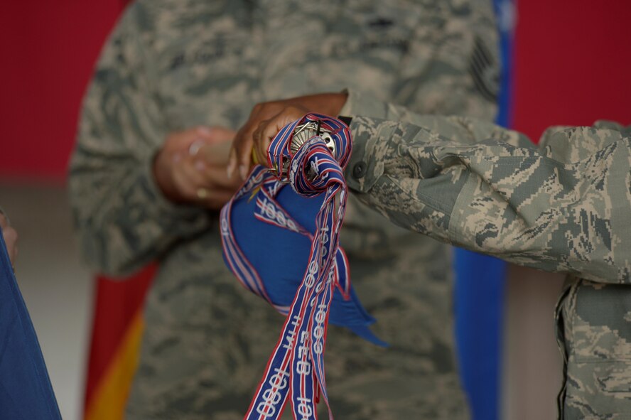 U.S. Air Force Maj. Strysan Murrell, 52nd MXS commander, retires the 52nd Component Maintenance Squadron guidon during a redesignation ceremony in Hangar One at Spangdahlem Air Base, Germany, July 14, 2016. The 52nd Component Maintenance Squadron and 52nd Equipment Maintenance Squadron have been retired and are now consolidated into the new 52nd Maintenance Squadron. (U.S. Air Force photo by Staff Sgt. Jonathan Snyder/Released)
