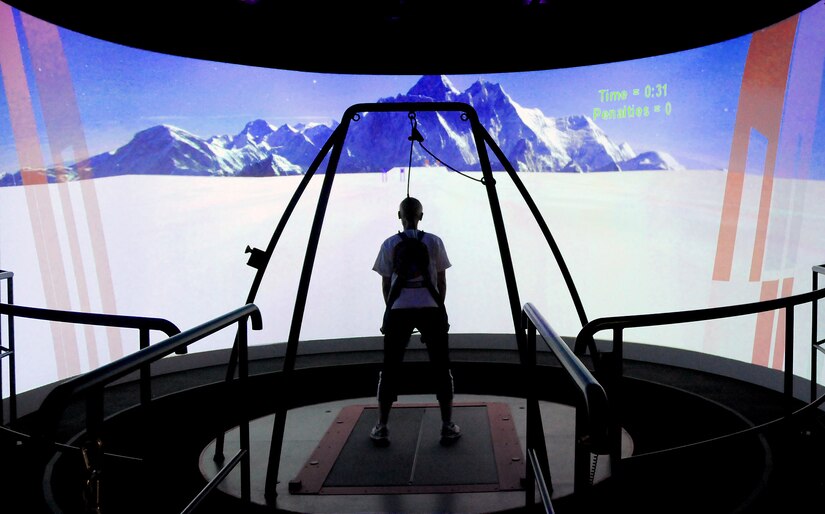 A technician demonstrates how a patient with a traumatic brain injury uses the Computer Assisted Rehabilitation Environment (CAREN) virtual reality to help them with movement and balance at the National Intrepid Center of Excellence in Bethesda, Maryland. (Courtesy photo)