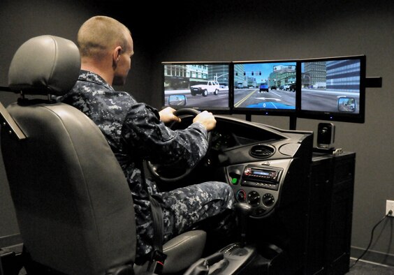 A technician demonstrates how a patient with a traumatic brain injury uses driving assessment and rehabilitation treatment to help in regaining the ability to drive their cars at the National Intrepid Center of Excellence in Bethesda, Md. (Courtesy photo)