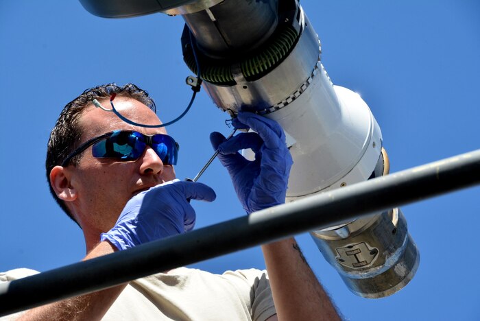 JOINT BASE PEARL HARBOR-HICKAM (July 10, 2016) Senior Airman Travis Krause, U.S. Air Force crew chief with the 507th Aircraft  Maintenance Squadron at Tinker  Air Force Base, Okla., prepares to remove the boom nozzle from a KC-135R Stratotanker in order to connect a drogue adapter and drogue. Twenty-six nations, more than 40 ships and submarines, more than 200 aircraft, and 25,000 personnel will participate in RIMPAC from June 30 to Aug. 4, in and around the Hawaiian Islands and Southern California. (U.S. Air Force photo/Master Sgt. Grady Epperly/Released)