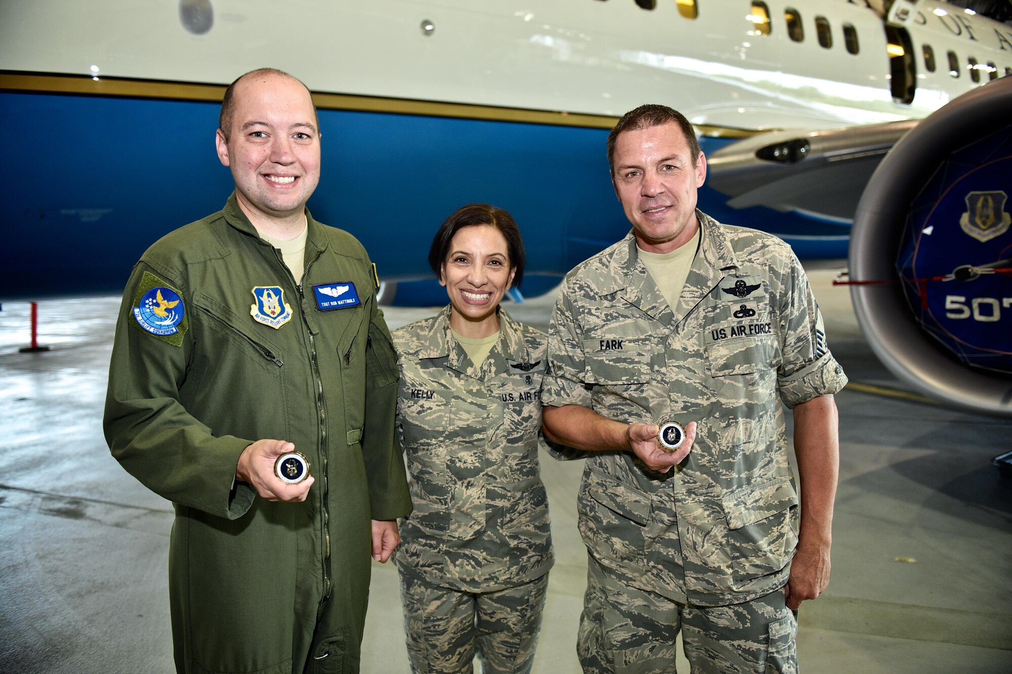Tech. Sgt. Rob Mattingly, left, and Master Sgt. Brian Fark, right, stand with Air Force Reserve Command, Command Chief, Chief Master Sgt. Ericka Kelly, July 8, 2016, Scott Air Force Base, Illinois. Both sergeants were given coins by Ericka for their outstanding customer service and professional manner working with dignitaries and representatives that fly with the 932nd Airlift Wing operational support and team travel aircraft.  (U.S. Air Force photo/Christopher Parr)