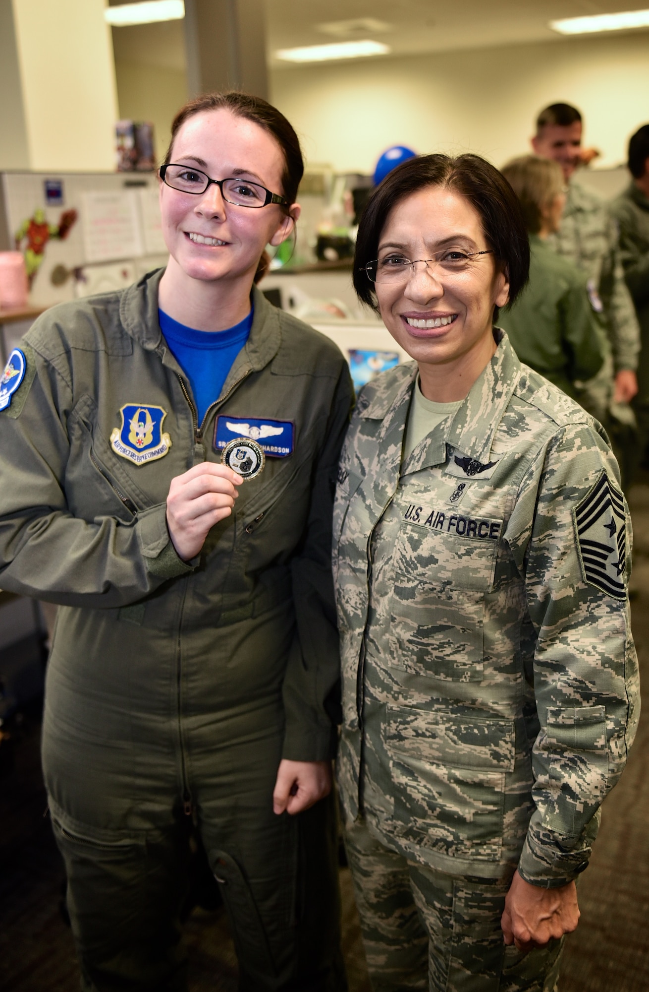 Senior Airman April Richardson, 932nd Airlift Wing Aeromedical Evacuation Squadron technician proudly holds her Chief's coin recently presented by the Air Force Reserve Command, Command Chief, Chief Master Sgt. Ericka Kelly, July 8, 2016, Scott Air Force Base, Illinois.  Richardson was noted as a standout Airman within the AES for her self improvements and positive attitude.  (U.S. Air Force photo/Christopher Parr)