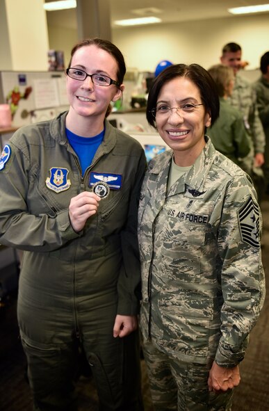 Senior Airman April Richardson, 932nd Airlift Wing Aeromedical Evacuation Squadron technician proudly holds her Chief's coin recently presented by the Air Force Reserve Command, Command Chief, Chief Master Sgt. Ericka Kelly, July 8, 2016, Scott Air Force Base, Illinois.  Richardson was noted as a standout Airman within the AES for her self improvements and positive attitude.  (U.S. Air Force photo/Christopher Parr)