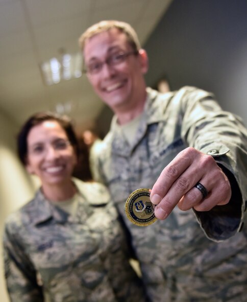 Master Sgt. John Linafelter, 1st Sgt. with 73rd Airlift Squadron, is all smiles while showing the coin recently given by Air Force Reserve Command, Command Chief, Chief Master Sgt. Ericka Kelly, July 8, 2016, Scott Air Force Base, Illinois.  The token of appreciation was given to Linafelter for his role in planning and leading the Professional Development Seminar and being an outstanding 1st Sgt. with the 73rd AS.  (U.S. Air Force photo/Christopher Parr) 