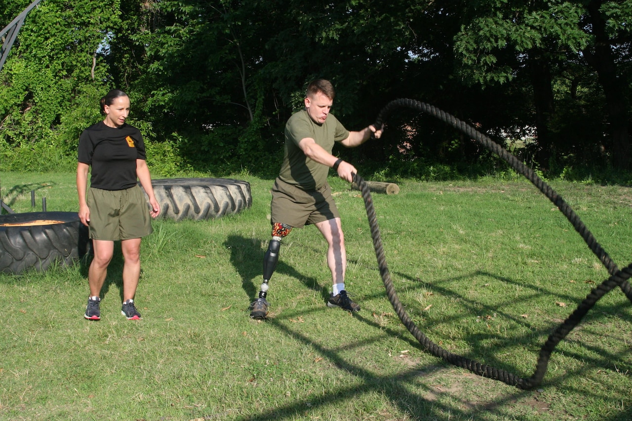 Marine Corps Master Sgt. Berle Sigman, a Faculty Advisors Course student at the Quantico Staff Noncommissioned Officer Academy at Marine Corps Base Quantico in Virginia, right, completes a high intensity tactical training physical training session with Marine Corps Master Gunnery Sgt. Amber Hecht, a lead instructor, June 27, 2016. Sigman graduated from the three-week course on June 29. Sigman’s original military occupational specialty was infantryman and he will teach warfighting classes at the SNCO academy. Sigman was injured in Ramadi, Iraq, in 2004, which led to the loss of his leg. Marine Corps Training and Education Command photo