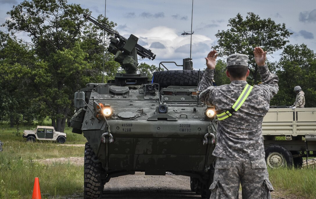 A U.S. Army Reserve solider with the 401st Chemical Company out of Boston, Mass., safely ground guides a Stryker nuclear, biological, and chemical reconnaissance vehicle during an equipment decontamination mission at Red Dragon on Fort McCoy, Wis., July 17, 2016. The Stryker NBCRV provides NBC detection and surveillance for battlefield hazard visualization. (U.S. Army photo by Master Sgt. Marisol Walker/Released)