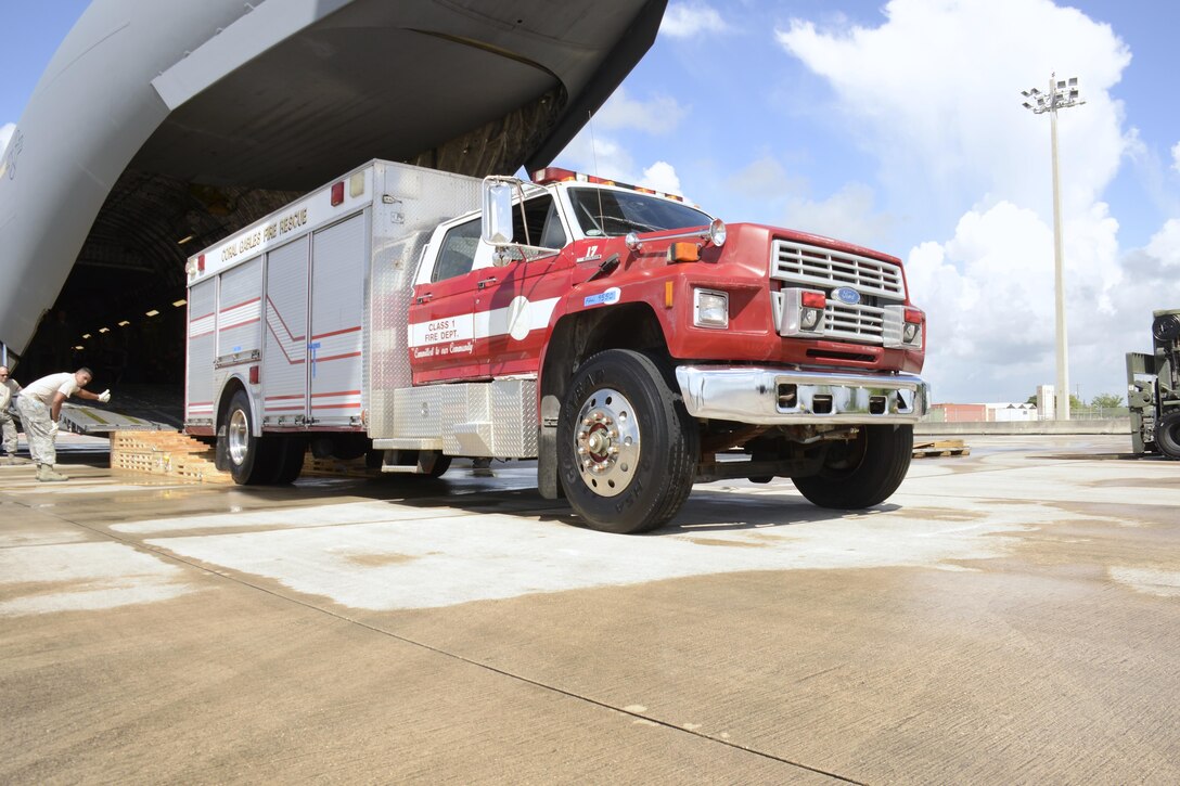 A fire rescue vehicle is backed into a C-17 Globemaster II on its way to La Antigua, Guatemala, July 17. This was the second fire rescue vehicle that was shipped out of Homestead ARB to a La Antigua. The first was shipped in April. (U.S. Air Force photo by Senior Airman Frank Casciotta)