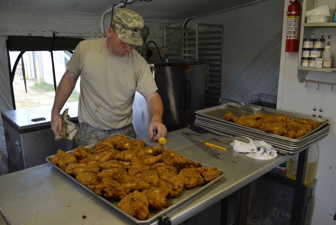 Army Reserve Sgt William Hernandez of 329th Combat Sustainment Support Battalion, from Parsons, Kans., verifies internal temperature of fried chicken for evening meal while at Warrior Exercise (WAREX) 86-16-03 at Ft. McCoy, Wis., July 15, 2016.  WAREX is designed to keep Soldiers all across the United States prepare to deploy.  (U.S. Army photo by SPC Joseph C. Driver/Released)