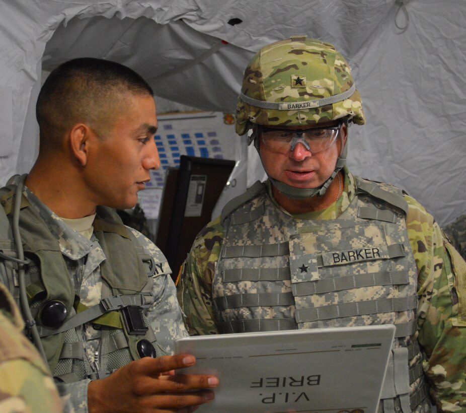 Army Reserve Staff Sgt. Richard Saenz (left) of 329th Combat Sustainment Support Battalion, headquartered in Parsons, Kansas, briefs Army Reserves Brig. Gen. Vincent B. Barker (right), commanding general of the 310th Sustainment Command (Expeditionary), during Warrior Exercise (WAREX) 86-16-03 at Ft. McCoy, Wis., July 12, 2016.  WAREX is designed to keep Soldiers all across the United States prepare to deploy.