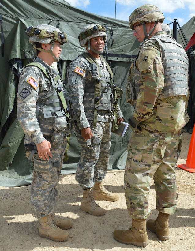 AArmy Reserve Brig. Gen. Vincent B. Barker (right), commanding general of the 310th Sustainment Command (Expeditionary), speaks to Command Sgt. Maj. Alma L. Ocasio (left) of 329th Command Sustainment Support Battalion (CSSB) and Lt. Col. Earl D. Terry III (center), battalion commander of the 329th CSSB during Warrior Exercise (WAREX) 86-16-03 at Ft. McCoy, Wis., July 12, 2016.  WAREX is designed to keep Soldiers all across the United States prepare to deploy.