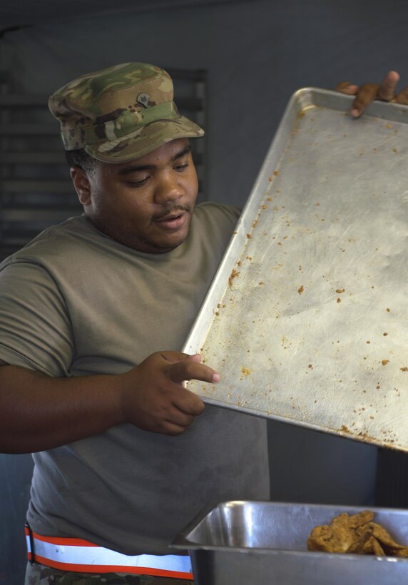 Army Reserve Spc. James Jones of 55th Sustainment Brigade, Ft. Belvoir, Va, prepares cooked food for soldiers for the evening meal while at Warrior Exercise (WAREX) 86-16-03 at Ft. McCoy, Wis., July 15, 2016.  WAREX is designed to keep Soldiers all across the United States prepare to deploy.  (U.S. Army photo by SPC Thomas Watters/Released)
