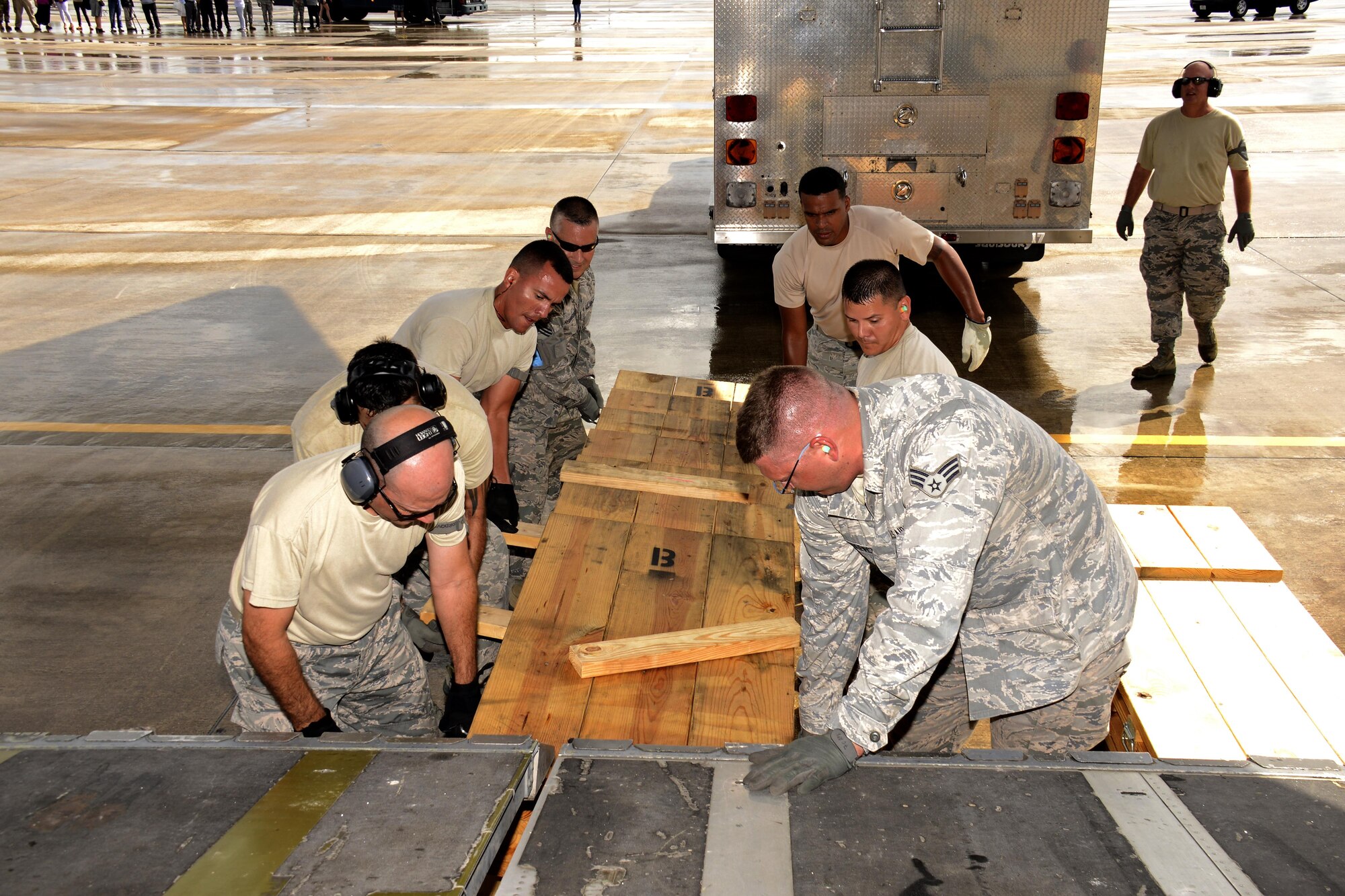 Airmen from the 70th Ariel Port Squadron assemble wooden shoring ramps for a fire rescue vehicle being loaded onto a C-17 Globemaster II on its way to La Antigua, Guatemala, July 17. This was the second fire rescue vehicle that was shipped out of Homestead ARB to a La Antigua. The first was shipped in April. (U.S. Air Force photo by Senior Airman Frank Casciotta)