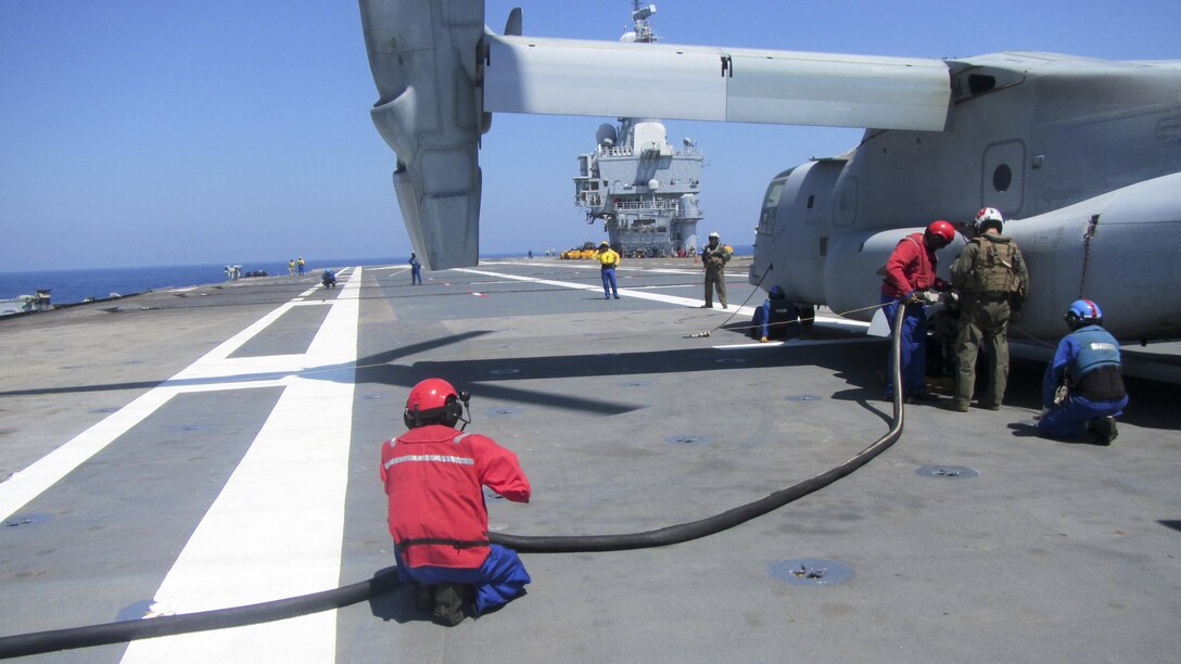 U.S. Marine Corps Cpl. Tyler J. Hansen, a crew chief with Marine Medium Tiltrotor Squadron 263, Special Purpose Marine Air-Ground Task Force-Crisis Response-Africa, works alongside French sailors to refuel an MV-22B Osprey aboard the French aircraft carrier Charles de Gaulle, in the Mediterranean Sea, July 6, 2016. This training allowed U.S. Marines and French sailors to practice deck procedures including tie-downs, taxiing and refueling the aircraft.