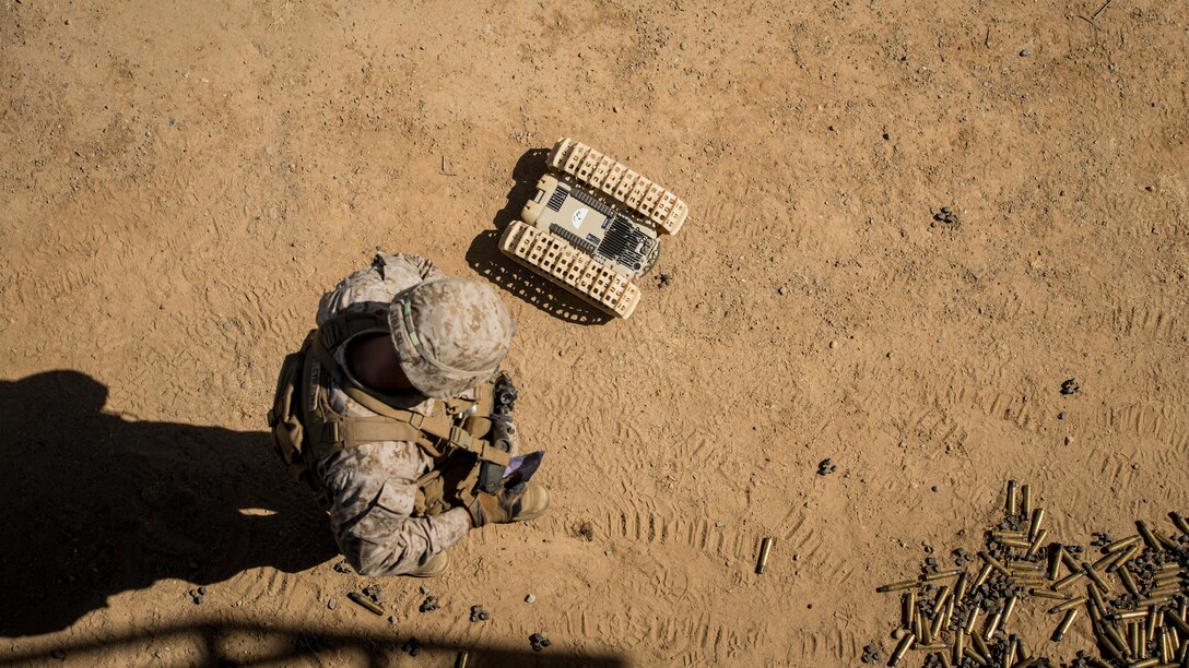 A Marine with 3rd Battalion, 5th Marine Regiment looks down at a “dragon fire” at Marine Corps Base Camp Pendleton, California, July 13, 2016. The system, meant to increase initial visibility of the enemy before the Marines need to engage them, was built by the Marine Corps Warfighting Laboratory. It can be tossed and kicked around, is invertible with front and rear cameras, and is both day and night capable. The lab is conducting a Marine Air-Ground Task Force Integrated Experiment in conjunction with Rim of the Pacific exercise to explore new gear and assess its capabilities for potential future use. The Warfighting Lab identifies possible challenges of the future, develops new warfighting concepts, and tests new ideas to help develop equipment that meets the challenges of the future operating environment.