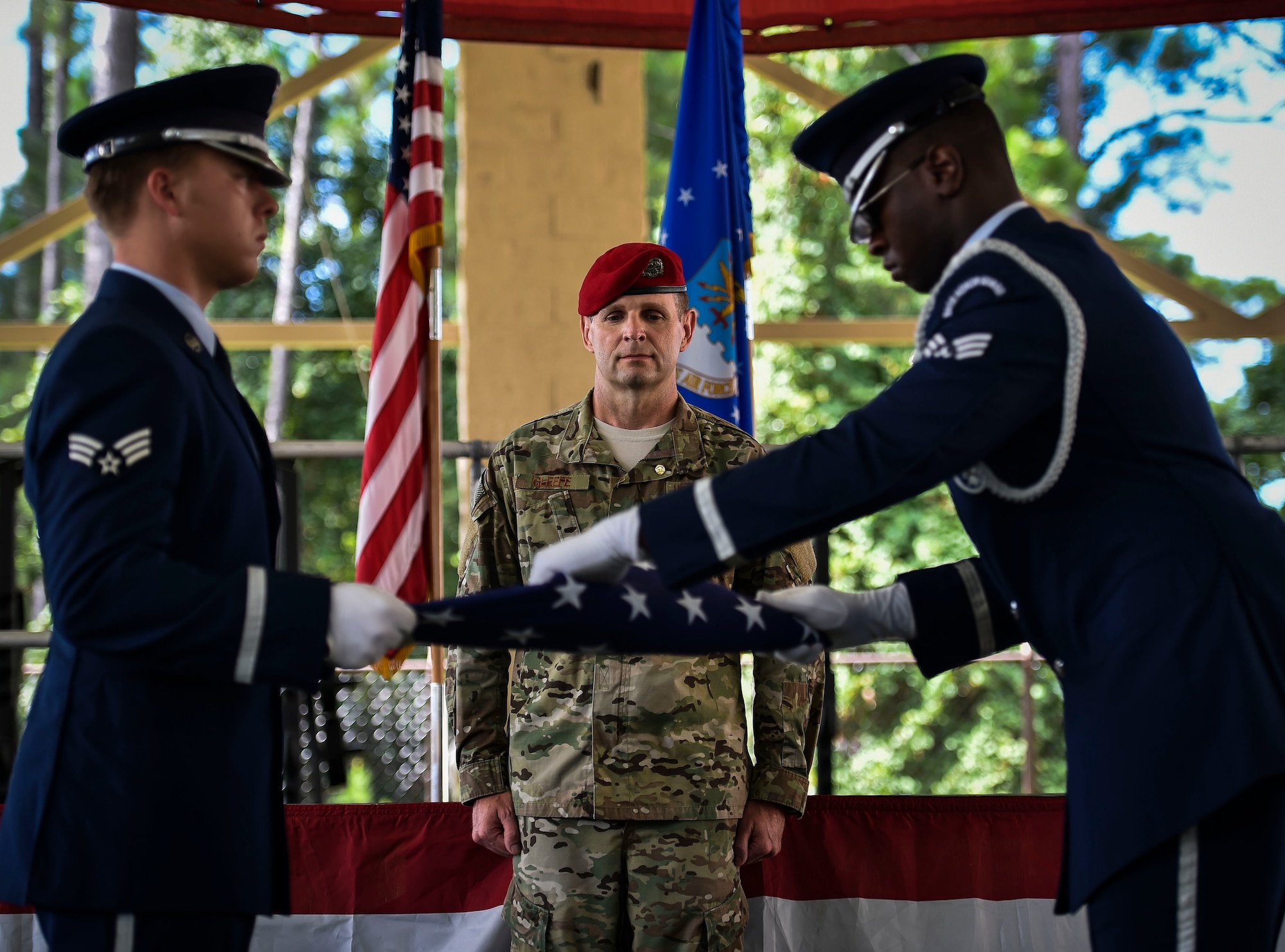 The Hurlburt Field Honor Guard fold an American Flag during Chief Master Sgt. Sean Gleffe’s, combat control functional manager for Air Force Special Operations Command, retirement ceremony at Hurlburt Field, Fla., July 15, 2016. Gleffe retired after 30 years as a Special Tactics combat controller. Throughout his Special Tactics career, Gleffe was certified a static line jump master, military freefall jump master and military dive supervisor. (U.S. Air Force photo by Senior Airman Ryan Conroy)