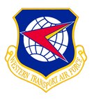 19 May 1958

Significance: The white globe represents the worldwide flying mission of the Western Transport Air Force (MATS) and our capability to support the Armed Forces in all parts of the world. The red and golden-yellow dart superimposed upon the globe, flying into the West, symbolizes the forward look of WESTAF and indicates the combined and coordinated mission of our immense operation over the worldwide airways. The blue field of the shield symbolizes our aim to accomplish the Air Force mission with safety, speed, and comfort. The emblem bears the Air Force colors, ultramarine blue and golden yellow, as well as the national colors, red, white, and blue. 