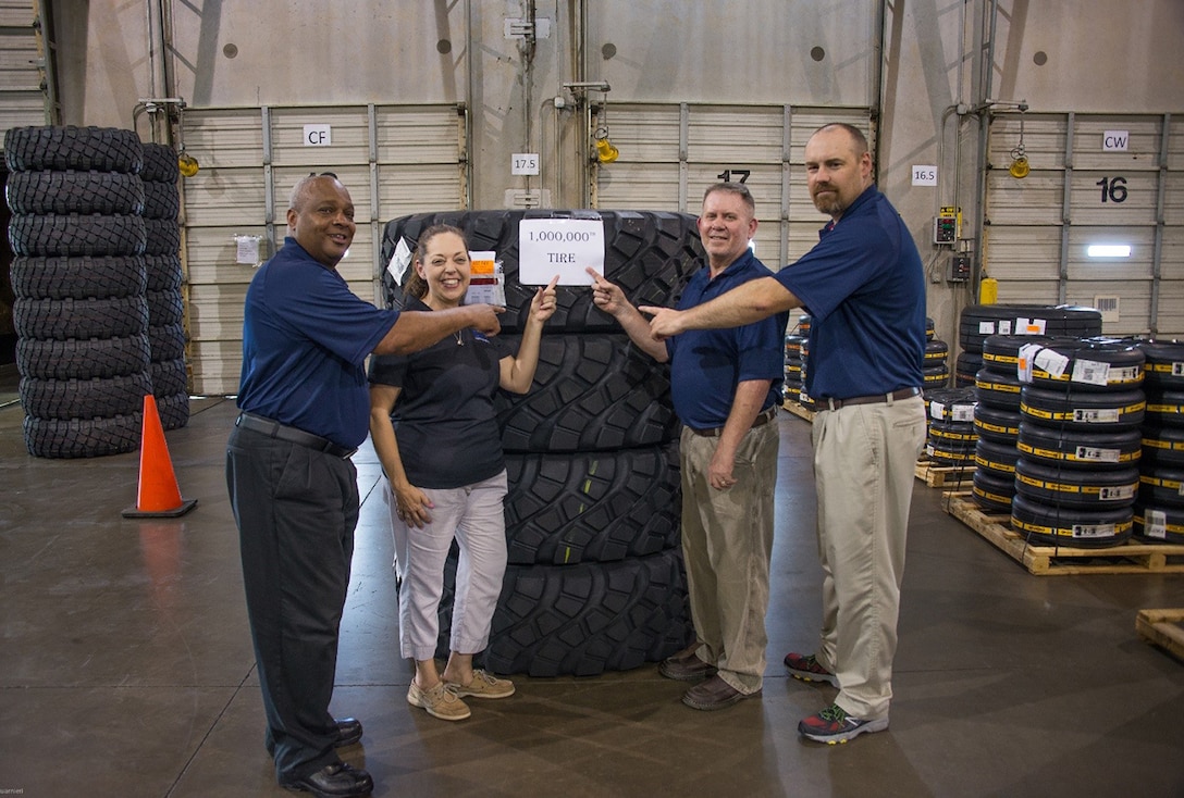 SAIC staff in the Fort Worth, Texas warehouse celebrating the Millionth tire delivered. (from left to right) Jeff Wynn, Lisa Miller, David Dahman and Brad Weaver.  Photo courtesy of SAIC.  
