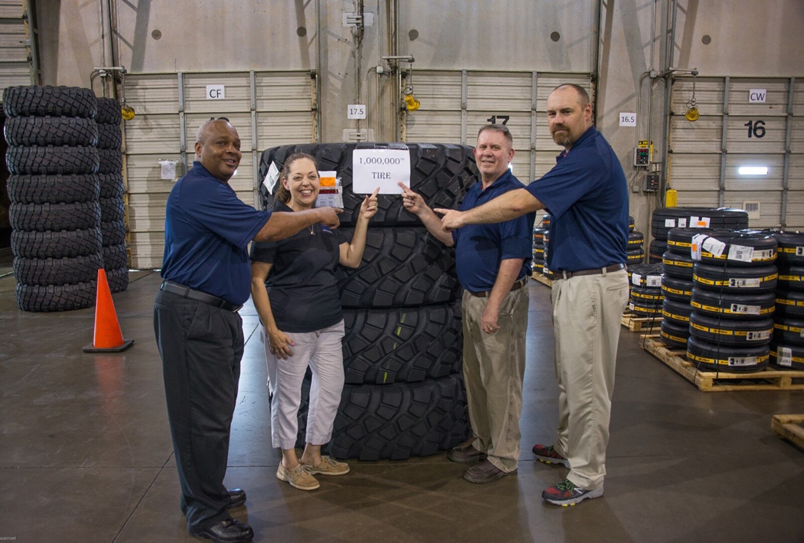 SAIC staff in the Fort Worth, Texas warehouse celebrating the Millionth tire delivered. (from left to right) Jeff Wynn, Lisa Miller, David Dahman and Brad Weaver.  Photo courtesy of SAIC.  