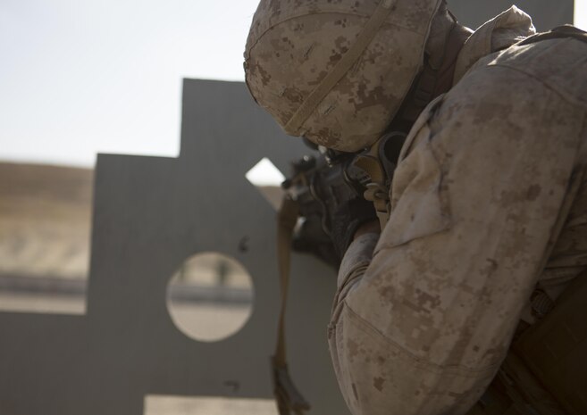 Lance Cpl. Christophe J. Belton takes aim at targets during a combat marksmanship course for 1st Marine Division’s annual Infantry Squad competitions. The competition pits squads from the 1st, 5th and 7th Marine Regiments along with one from a Light Armored Reconnaissance Battalion against one another in marksmanship, physical fitness and squad-level tactics. Belton, a native of Los Angeles is a rifleman with Company K, 3rd Battalion, 1st Marine Regiment, 1st Marine Division. (U.S. Marine Corps Photo by Lance Cpl. Justin E. Bowles)