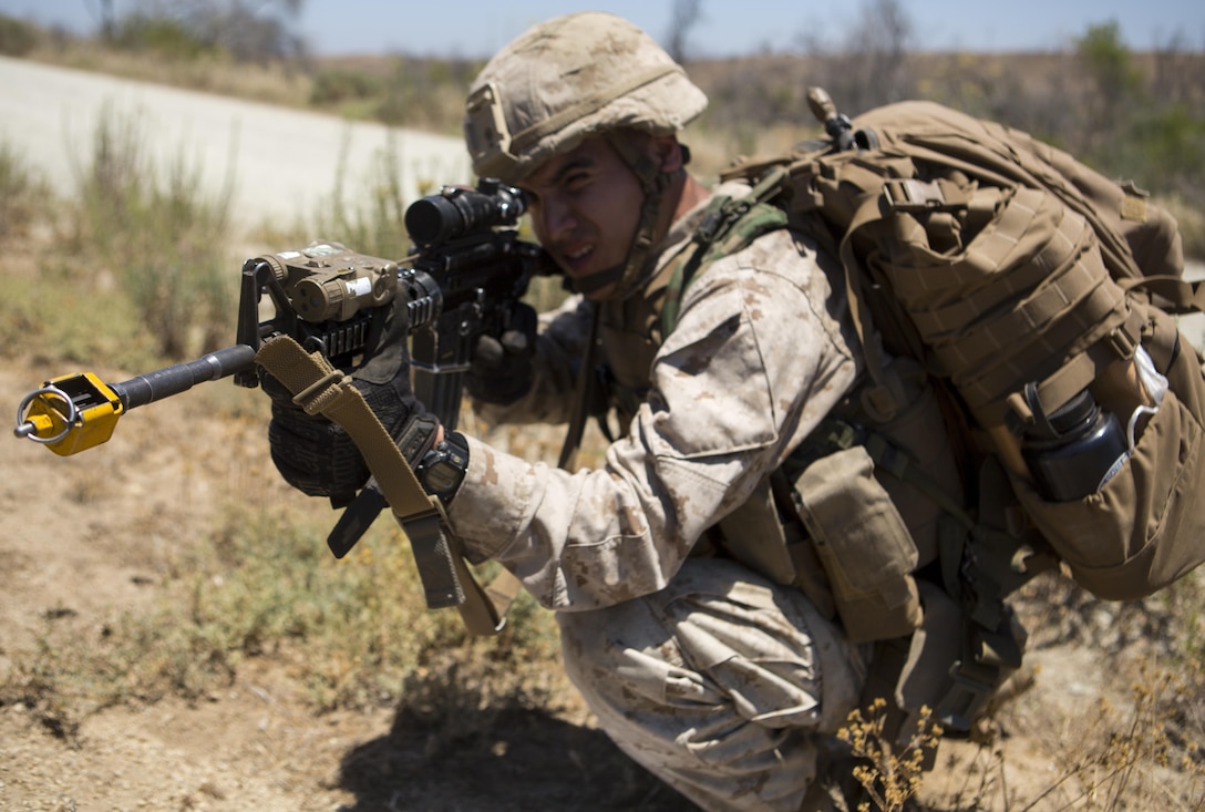 Lance Cpl. Jaime J. Camacho takes aim at a simulated enemy for 1st Marine Division’s annual Infantry Squad competitions. The competition pits squads from the 1st, 5th and 7th Marine Regiments along with one from a Light Armored Reconnaissance Battalion against one another in marksmanship, physical fitness and squad-level tactics. Camacho, a native of Laredo, Texas, is a rifleman with Company K, 3rd Battalion, 1st Marine Regiment, 1st Marine Division. (U.S. Marine Corps Photo by Lance Cpl. Justin E. Bowles)