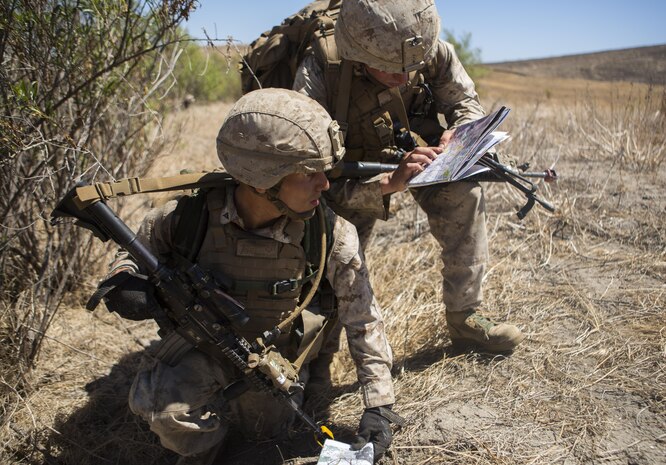 Lance Cpl. Jaime J. Camacho and Cpl. Edward R. O’Reilly consult a map to ensure their squad is hiking in the right direction during 1st Marine Division’s annual Infantry Squad competitions. The competition pits squads from the 1st, 5th and 7th Marine Regiments along with one from a Light Armored Reconnaissance Battalion against one another in marksmanship, physical fitness and squad-level tactics. Camacho, a native of Laredo, Texas, is a team leader and O’Reilly, a native of Chicago, Illinois, is a squad leader with Company K, 3rd Battalion, 1st Marine Regiment, 1st Marine Division. (U.S. Marine Corps Photo by Lance Cpl. Justin E. Bowles)