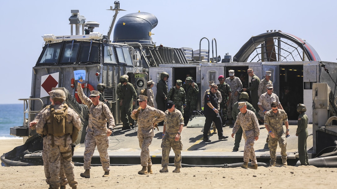 Senior U.S. and foreign military leaders attending an amphibious landing demonstration depart a Landing Craft Air Cushion during the USPACOM Amphibious Leaders Symposium at Marine Corps Base Camp Pendleton, California, July 13, 2016. PALS brings together senior leaders of allied and partner nations from the Indo-Asia-Pacific region to discuss key aspects of maritime/amphibious operations, capability development, crisis response, and interoperability. Twenty-two allied and partnered nations, including the U.S. are participating.