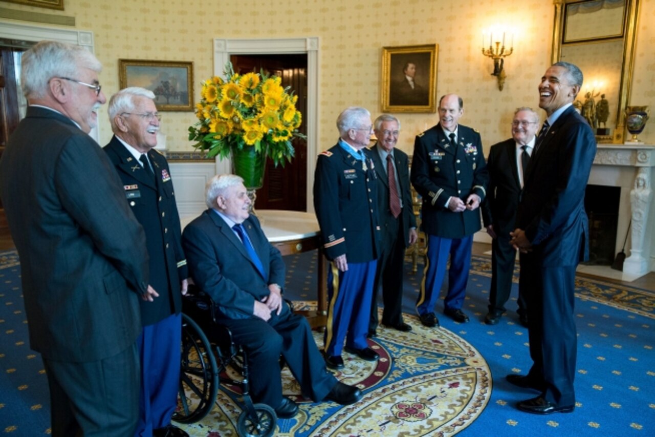 President Barack Obama talks with retired Army Lt. Col. Charles Kettles, center, and his guests, former brothers-in-arms from Vietnam, in the Blue Room following the Medal of Honor ceremony for Kettles at the White House, July 18, 2016. Then-Major Kettles distinguished himself in combat operations near Duc Pho, Republic of Vietnam, on May 15, 1967, and is credited with saving the lives of 40 soldiers and four of his own crew members. Official White House Photo by Pete Souza