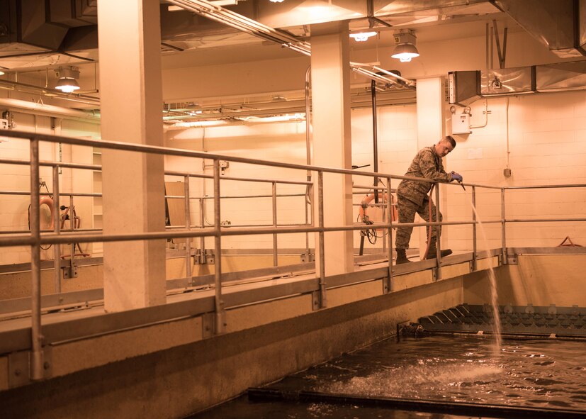 U.S. Air Force Airman 1st Class Troy Moncrief, a 354th Civil Engineering Squadron wastewater apprentice, displays solids removed from sewage after he removed it from a trap underground at the Eielson Air Force Base, Alaska, wastewater treatment plant July 14, 2016. Anything that cant be treated by aeration, bacteria or chemicals is removed prior to entering settling tanks and ponds. (U.S. Air Force photo by Staff Sgt. Shawn Nickel)
