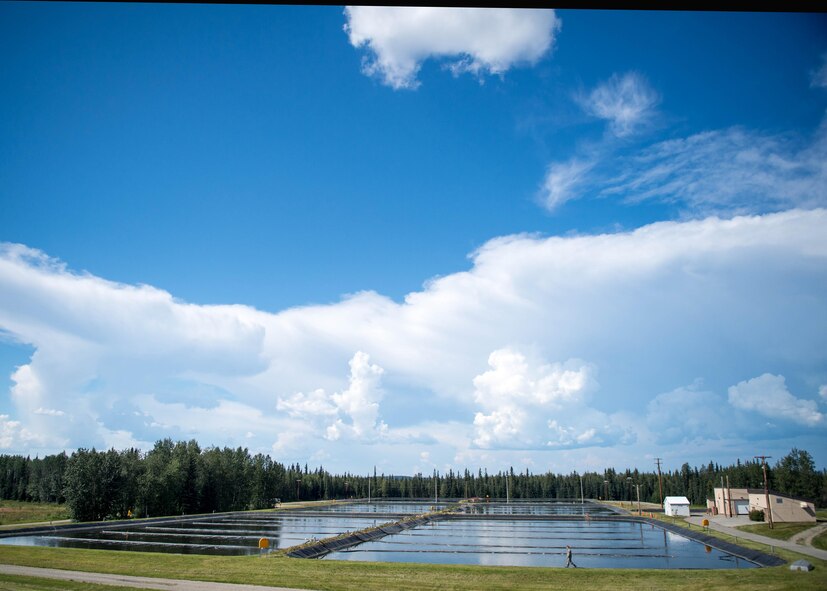 U.S. Air Force Airman 1st Class Troy Moncrief, a 354th Civil Engineering Squadron wastewater apprentice, uses a boat to inspect aeration equipment in ponds at the Eielson Air Force Base, Alaska, wastewater treatment plant July 15, 2016. The manufactured holding pond lined with thick black plastic hold millions of gallons of waste that is treated in a week’s time after it enters the plant. (U.S. Air Force photo by Staff Sgt. Shawn Nickel)
