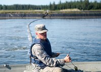 U.S. Air Force Airman 1st Class Troy Moncrief, a 354th Civil Engineering Squadron wastewater apprentice, uses a boat to inspect aeration equipment in ponds at the Eielson Air Force Base, Alaska, wastewater treatment plant July 15, 2016. The manufactured holding pond lined with thick black plastic hold millions of gallons of waste that is treated in a week’s time after it enters the plant. (U.S. Air Force photo by Staff Sgt. Shawn Nickel)
