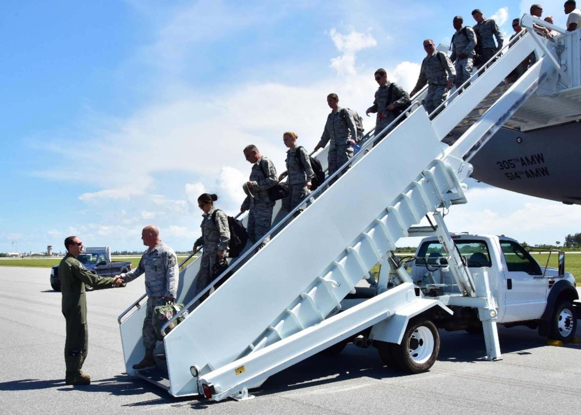 Lt. Col. Brian Cusson, 47th Fighter Squadron commander, greets Airmen from the 924th Fighter Group as they arrive July 16 for their annual tour on Patrick Air Force Base, Fla. Approximately 200 Airmen from the 924th will conduct their annual tour at Patrick AFB, allowing the unit to gain experience and train with the 920th Rescue Wing. (U.S. Air Force photo by Tech. Sgt. Louis Vega Jr.) 