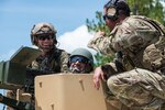 Army Col. Erick Rolando Montiel Aldana, commander, 1st Infantry Brigade from Guatemala, discussed the capabilties of the Browning M2 machine gun with members of the 3rd Battalion, 20th Special Forces Group during a convoy live fire demonstation at Camp Blanding Joint Training Center, July 13, 2016.