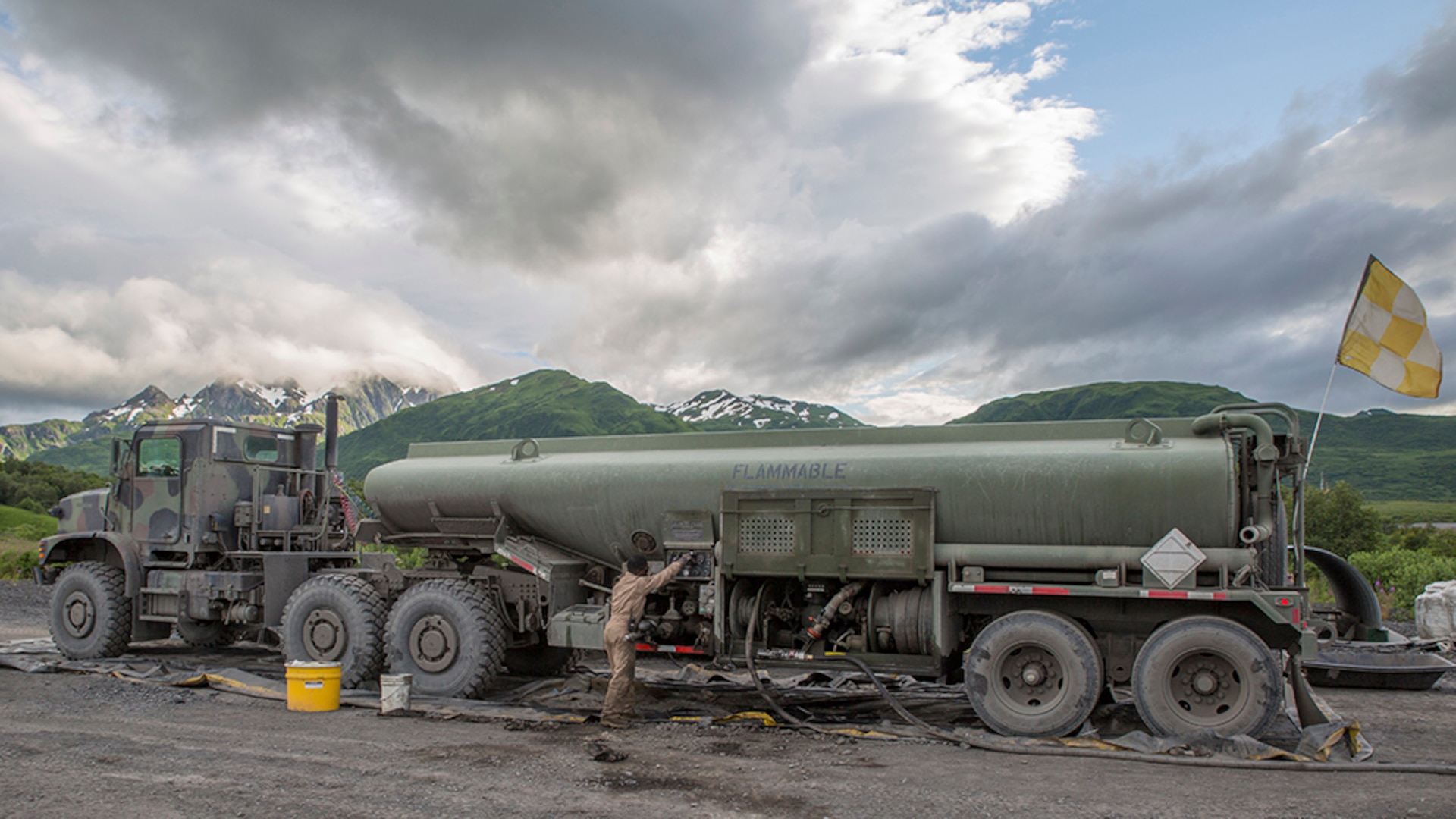 Cpl. Kuwyn Diggs, a semitrailer refueler operator with Detachment (-), Marine Wing Support Squadron-472, Marine Aircraft Group 49, 4th Marine Aircraft Wing, Marine Forces Reserve, performs maintenance on an AMK 970 semitrailer refueler during Innovative Readiness Training Old Harbor, Alaska, July 10, 2016. IRT Old Harbor is part of a civil and joint military program to improve military readiness while simultaneously providing quality services to underserved communities throughout the United States. 