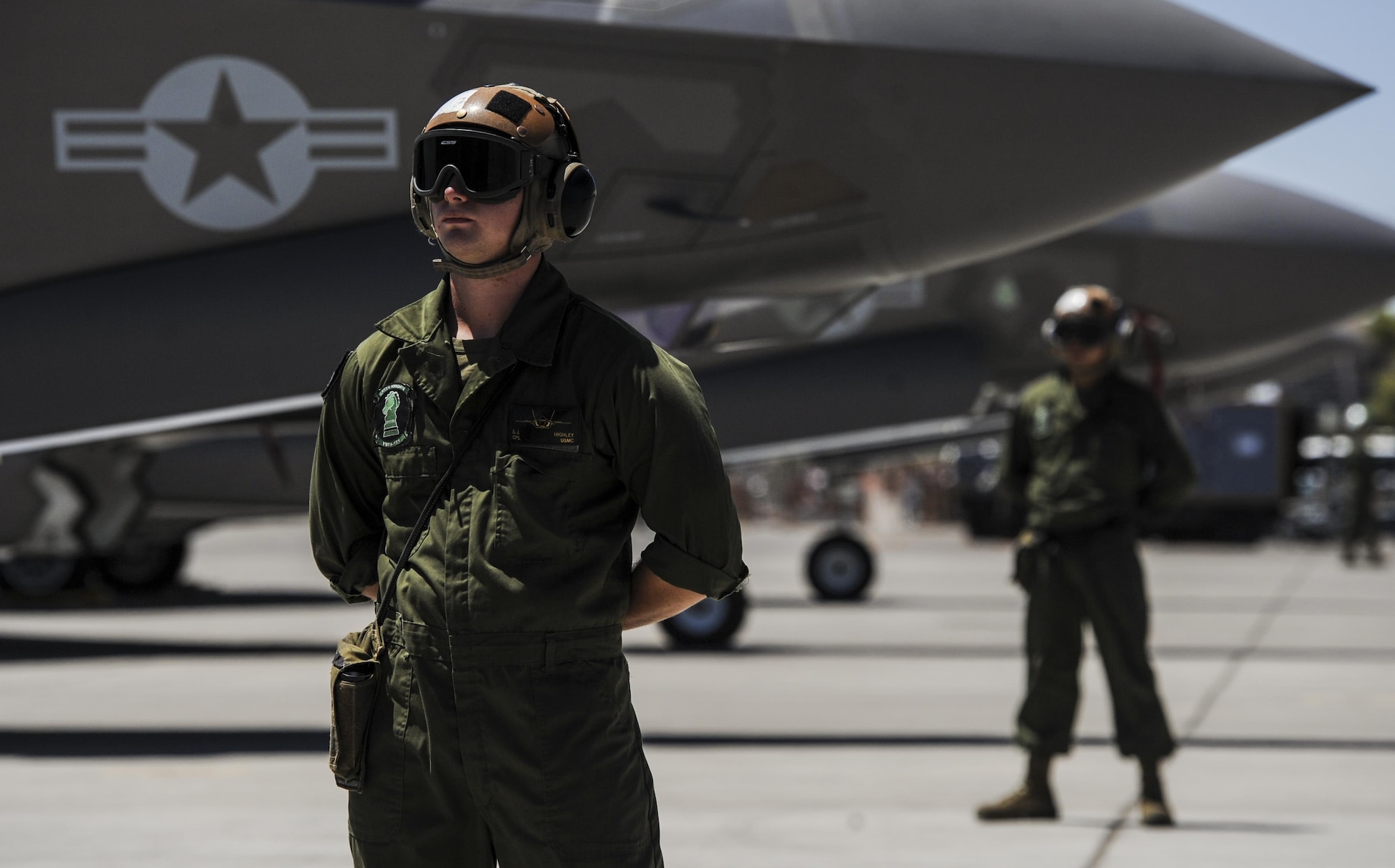 Corporal Highley, assigned to the 3rd Marine Aircraft Wing, Marine Corps Air Station Yuma, Az., prepares to marshal an F-35B during Red Flag 16-3 at Nellis Air Force Base, Nev., July 12, 2016. Red Flag is an exercise hosted at Nellis AFB that provides air crews an opportunity to experience realistic, stressful combat situations in a controlled environment to increase mission capability. (U.S. Air Force photo by Airman 1st Class Kevin Tanenbaum)